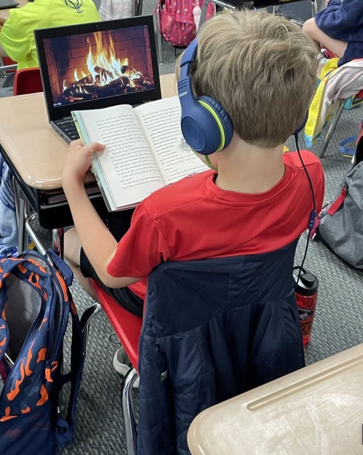 kid reading with fireplace on computer - Pow